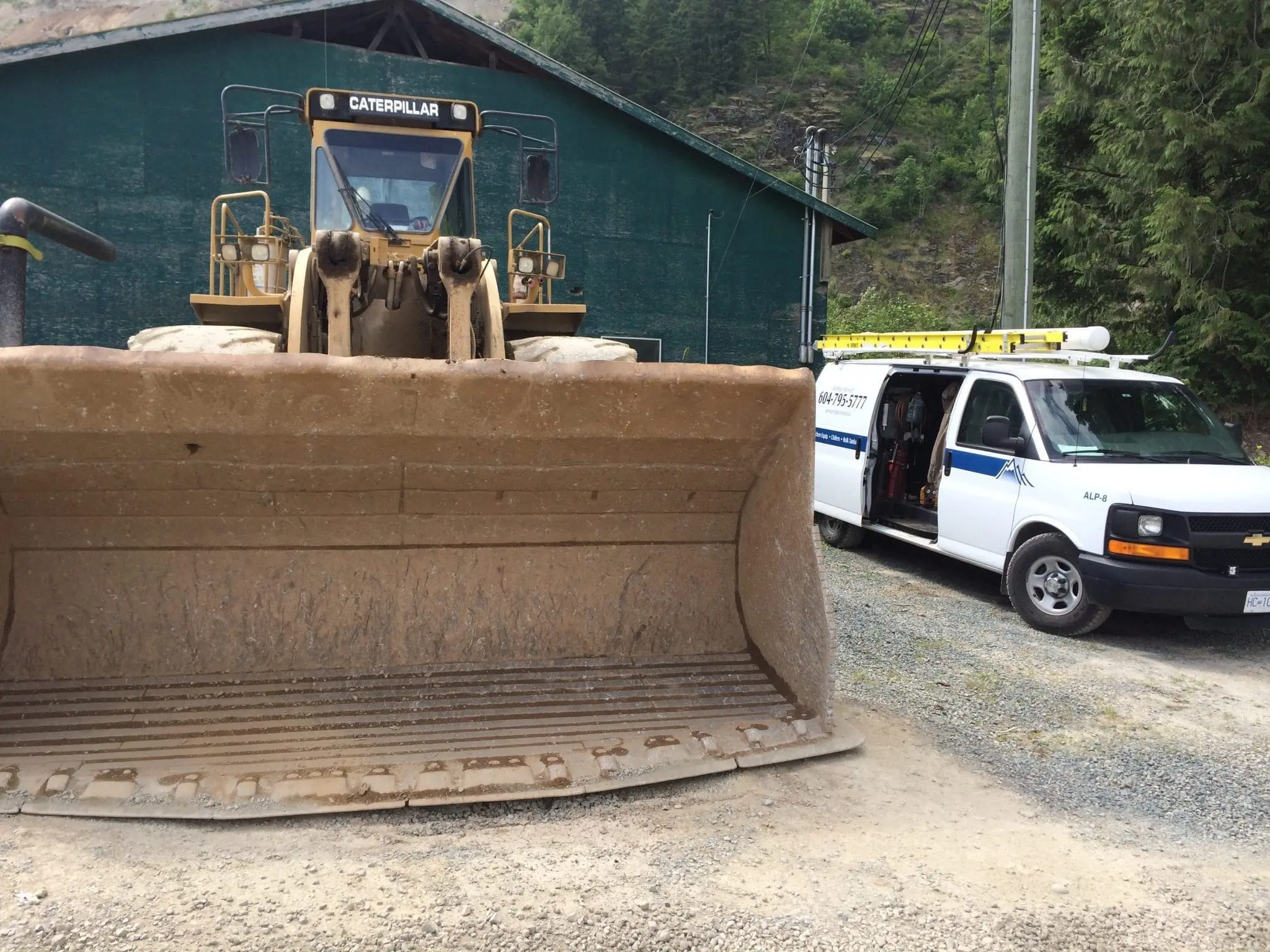 Remote Location Mining Site Service Alpine Refrigeration service van next to Caterpillar equipment at remote mining site