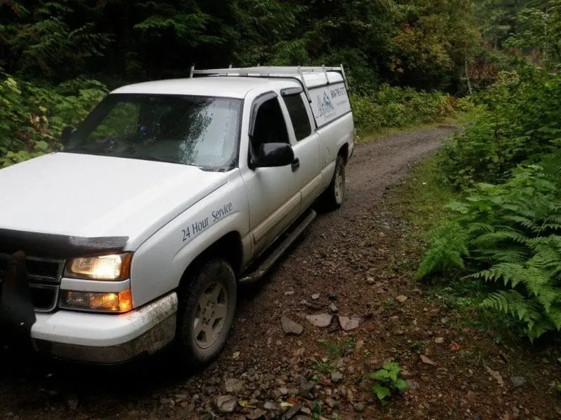 Remote Emergency Service Access Alpine Refrigeration service truck on remote forest access road for 24 hour emergency service