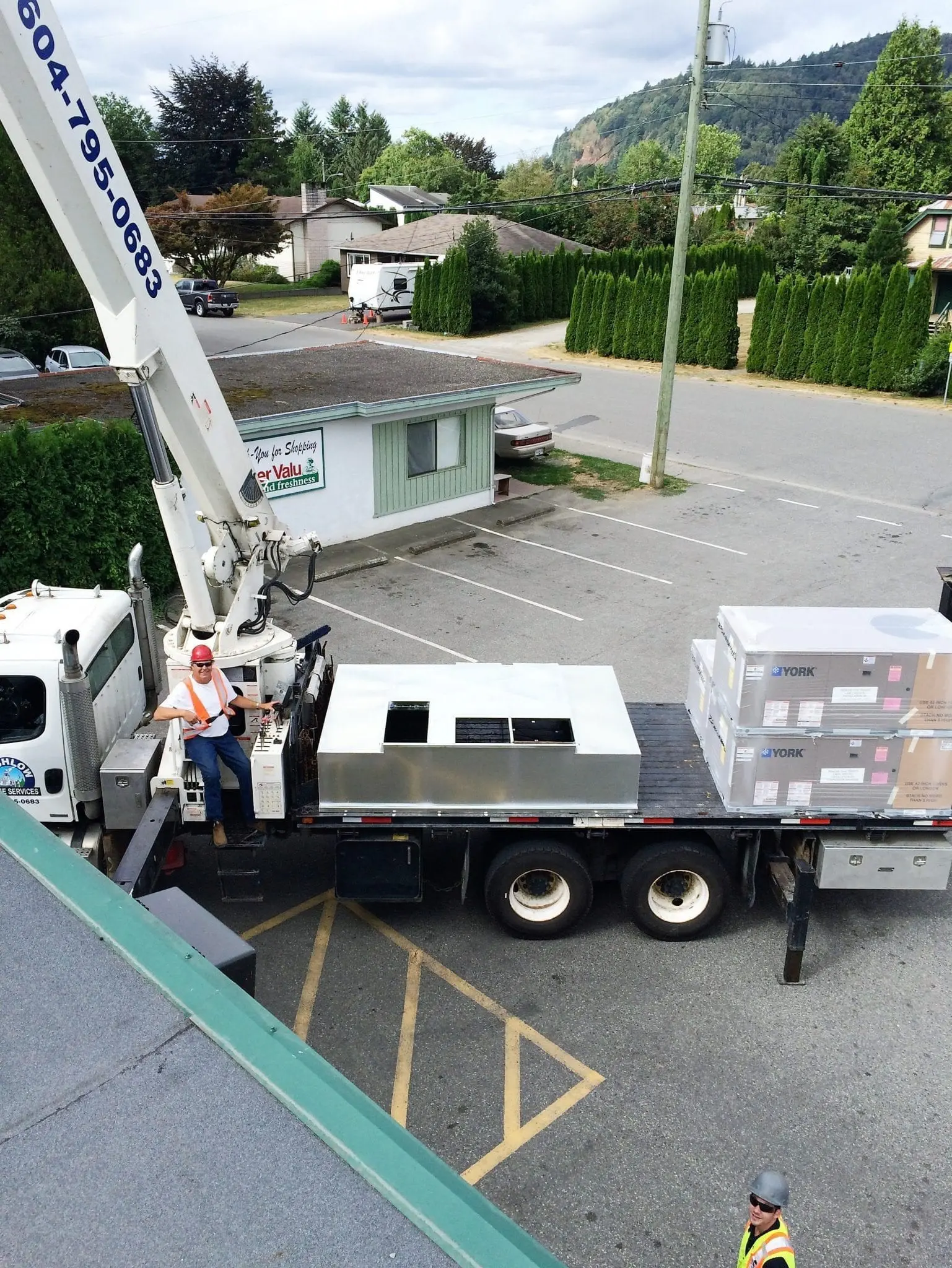 Rooftop HVAC Unit Installation Alpine Refrigeration crane lift installing York HVAC rooftop units