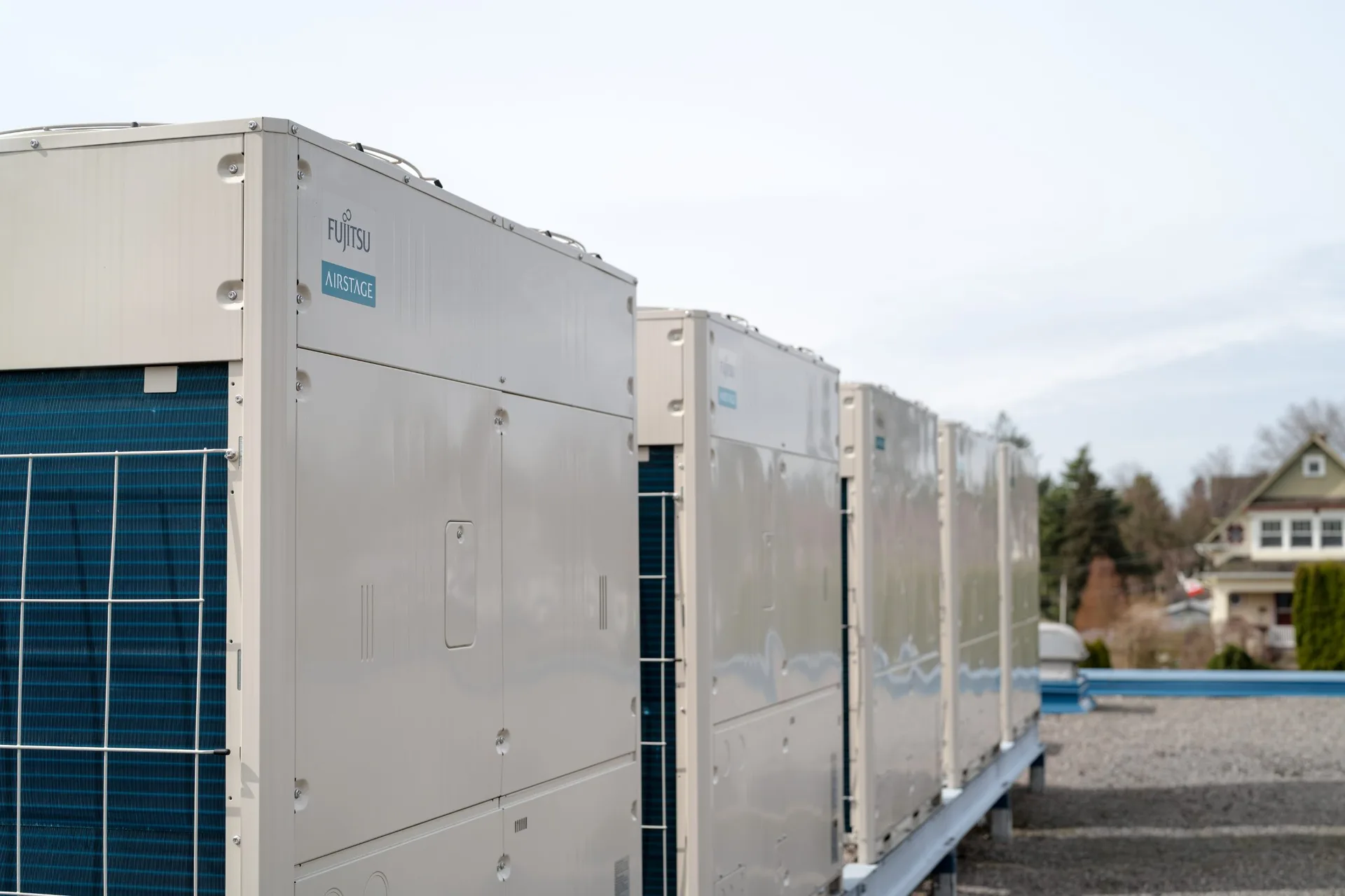 Row of Fujitsu AIRSTAGE VRF outdoor units installed by Alpine Refrigeration on a Fraser Valley rooftop